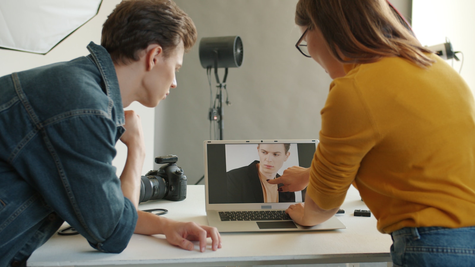 A photographer discussing selected images on a laptop