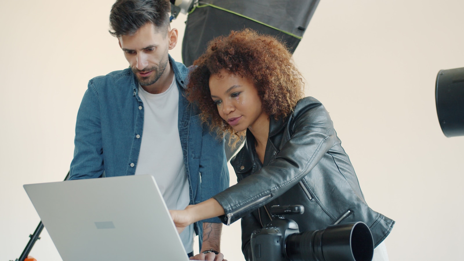 A client reviewing finished portraits with a photographer