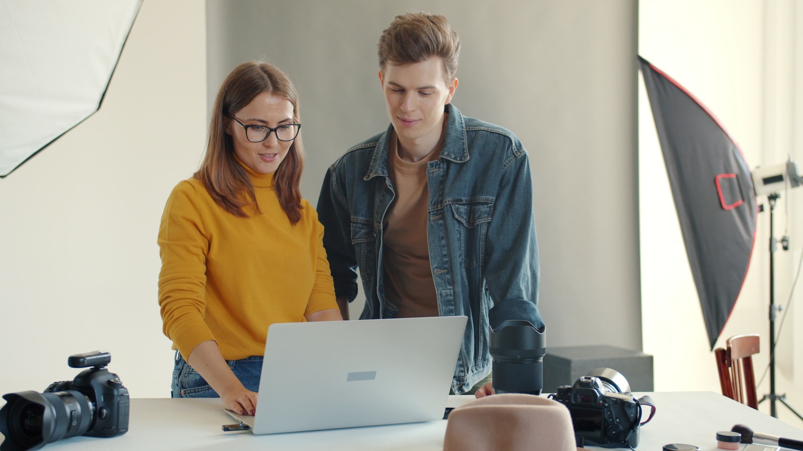 A photographer and client reviewing images on a laptop