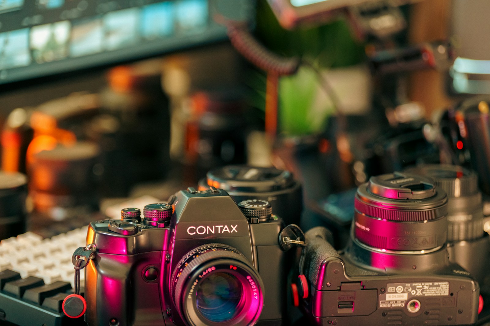 A collection of cameras and lenses on a studio desk