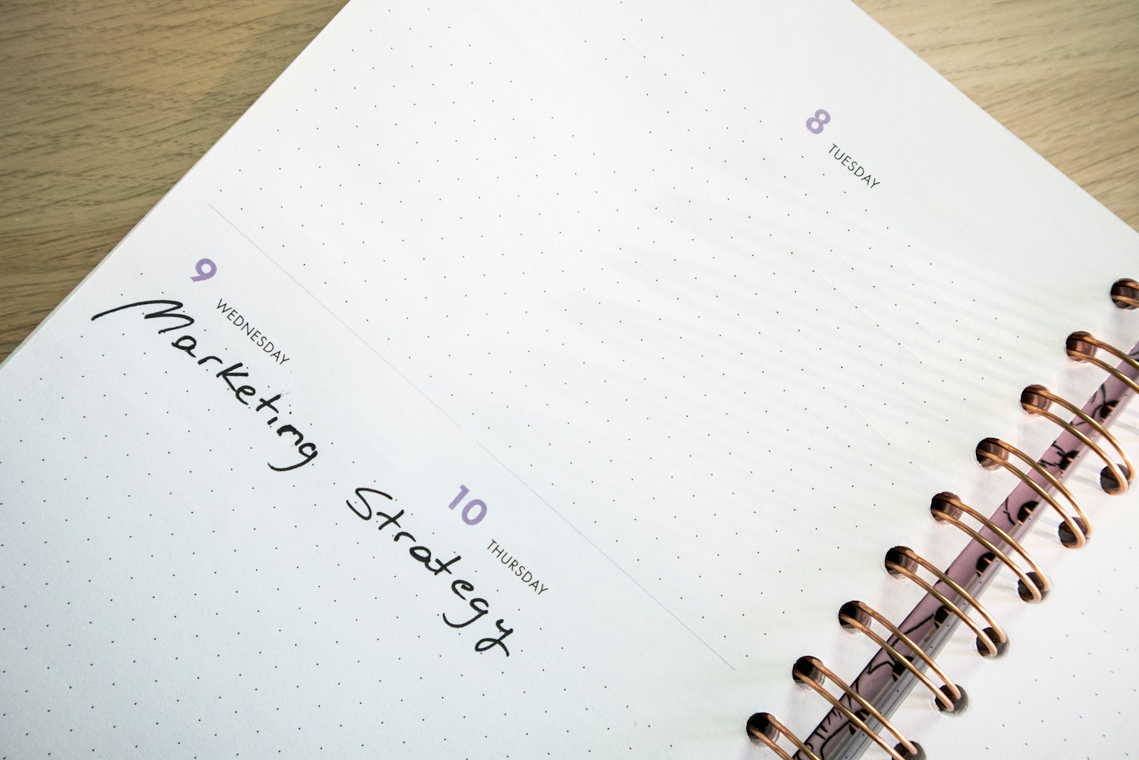 A paper planner and pen used to build an event timeline
