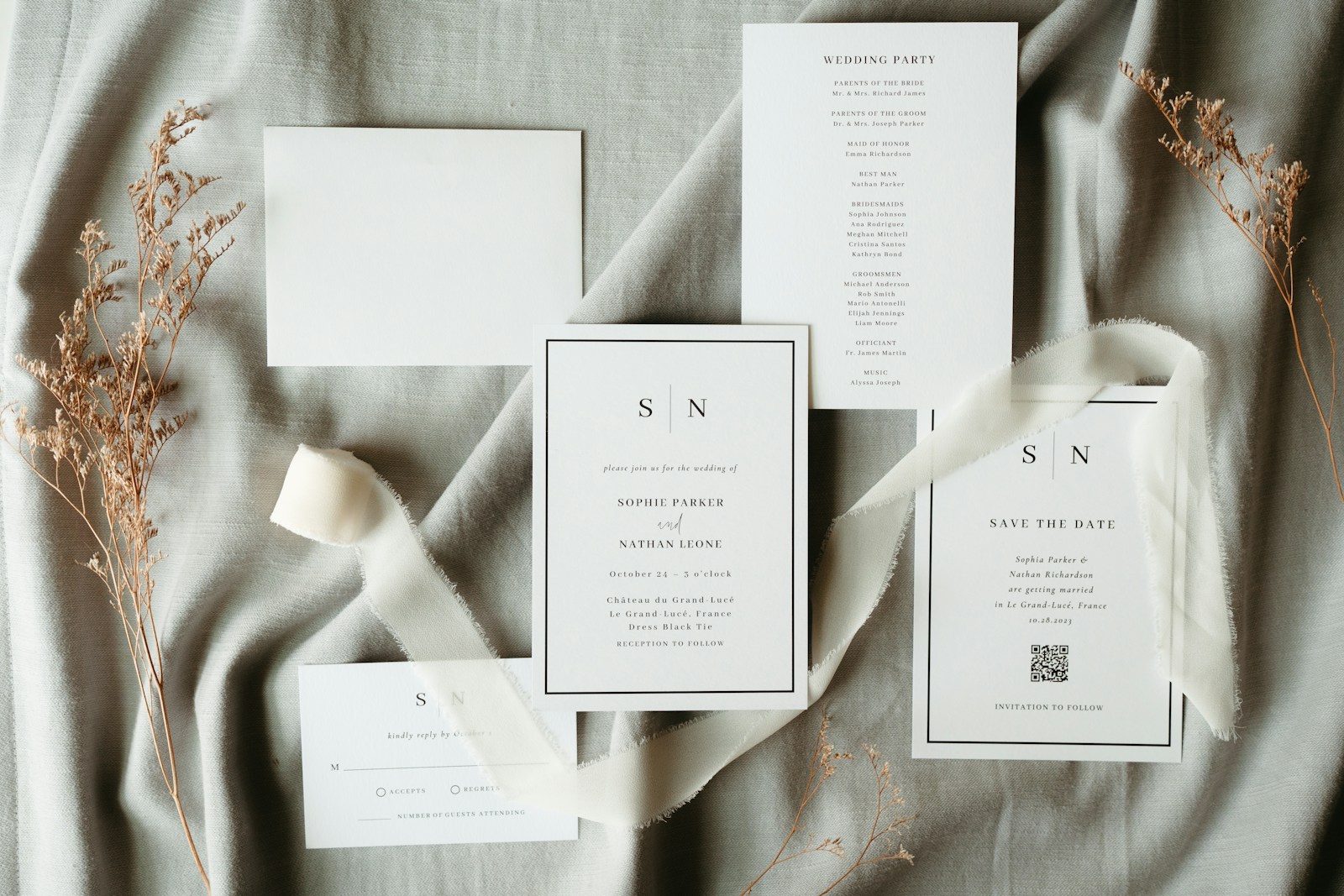 A wedding stationery suite arranged on a bed