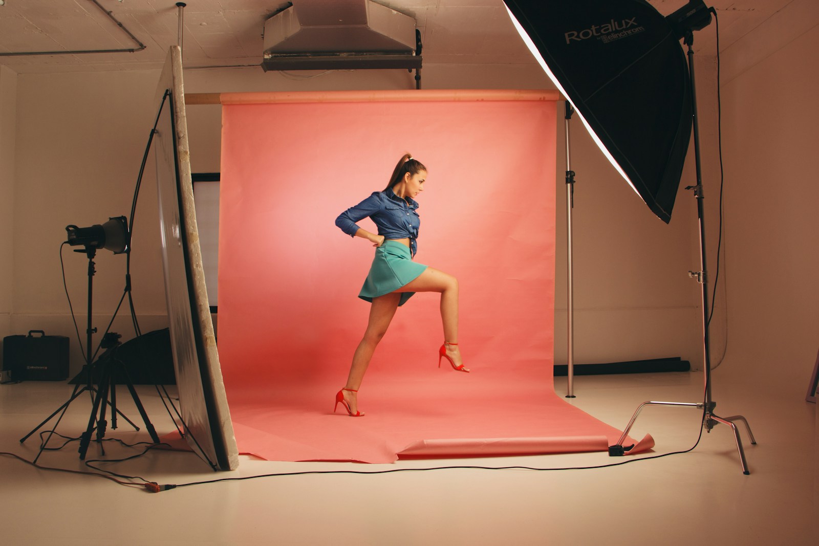 A portrait subject posing in front of a studio softbox