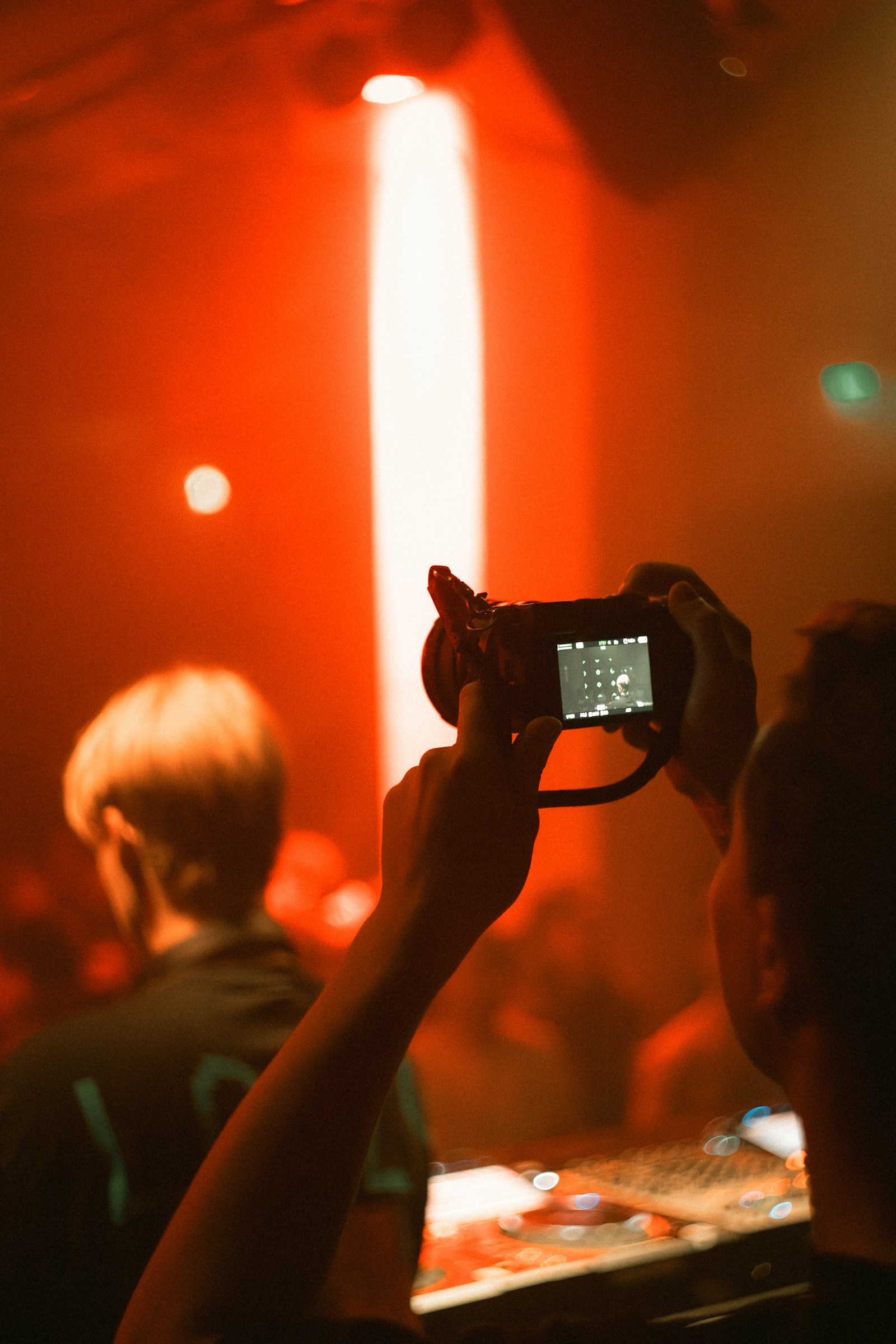 A guest filming a concert with a compact digital camera