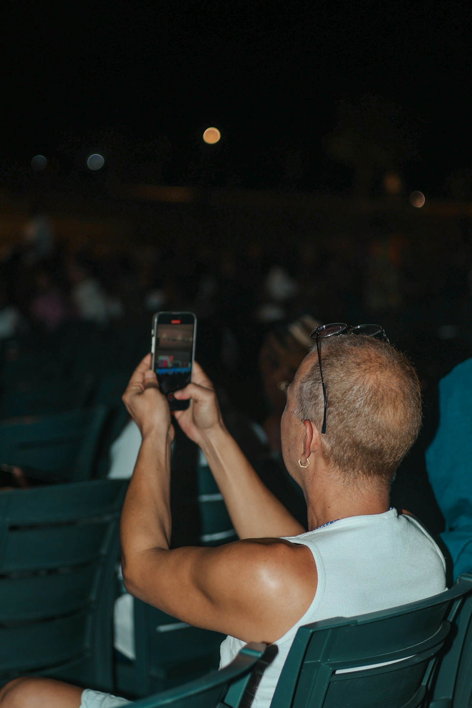 A guest recording a live event on a smartphone