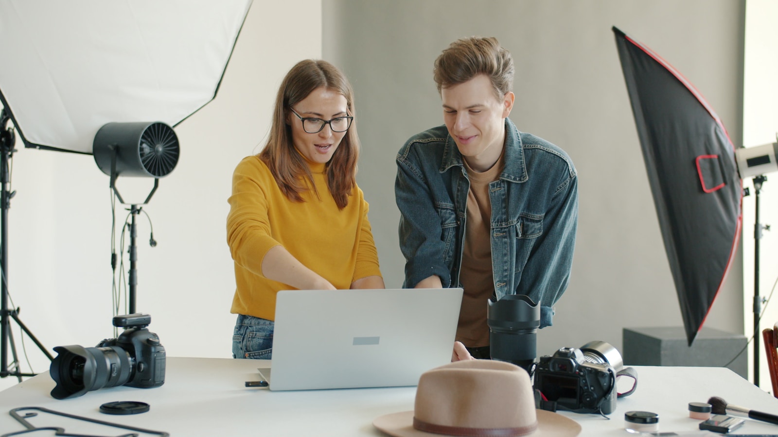 A creative team reviewing photography on a laptop