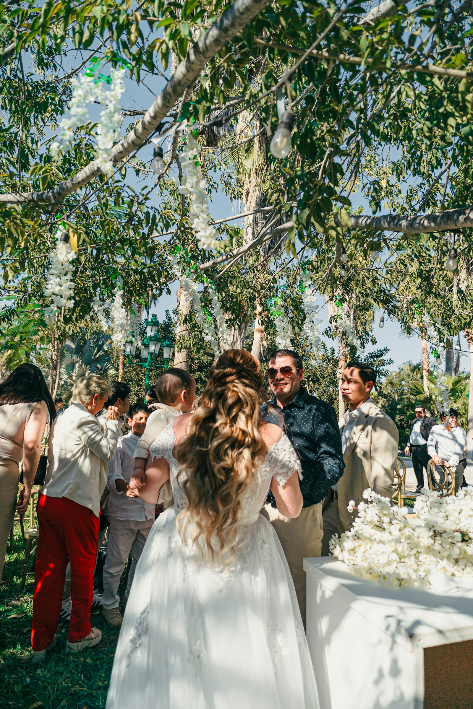 A couple celebrating with friends at an outdoor wedding